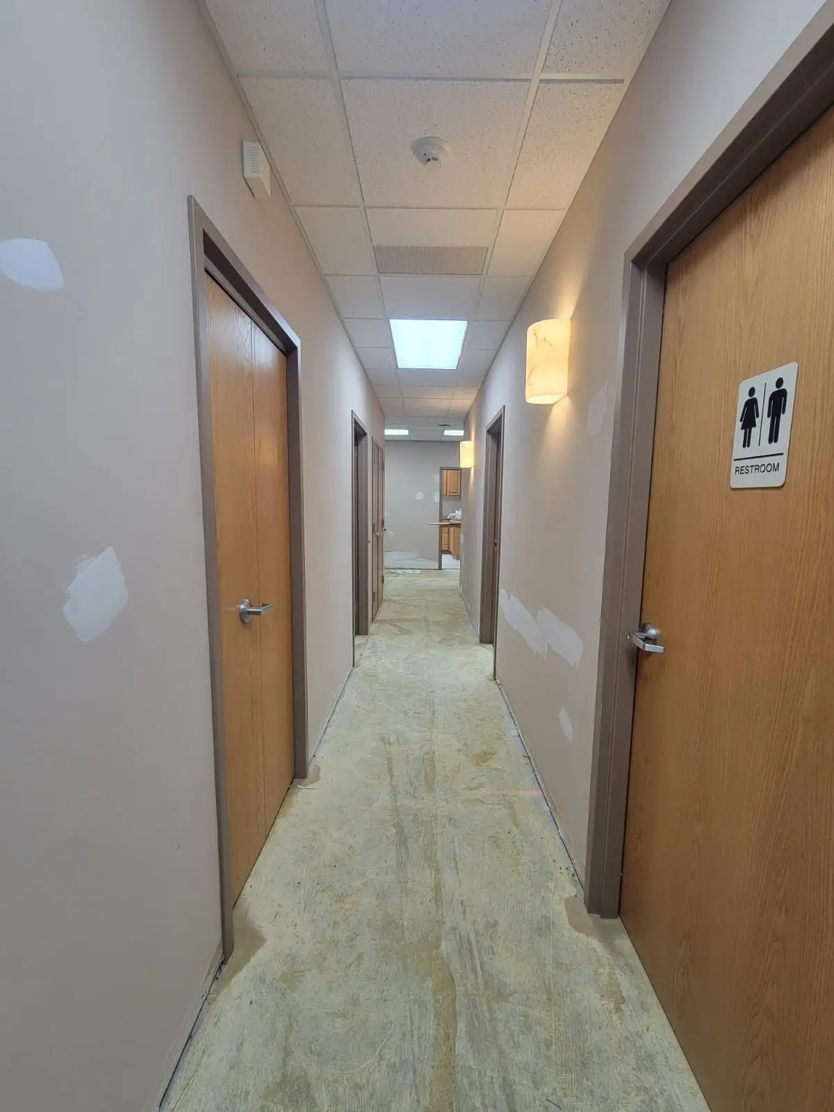 Finished commercial corridor with painted walls and new doors