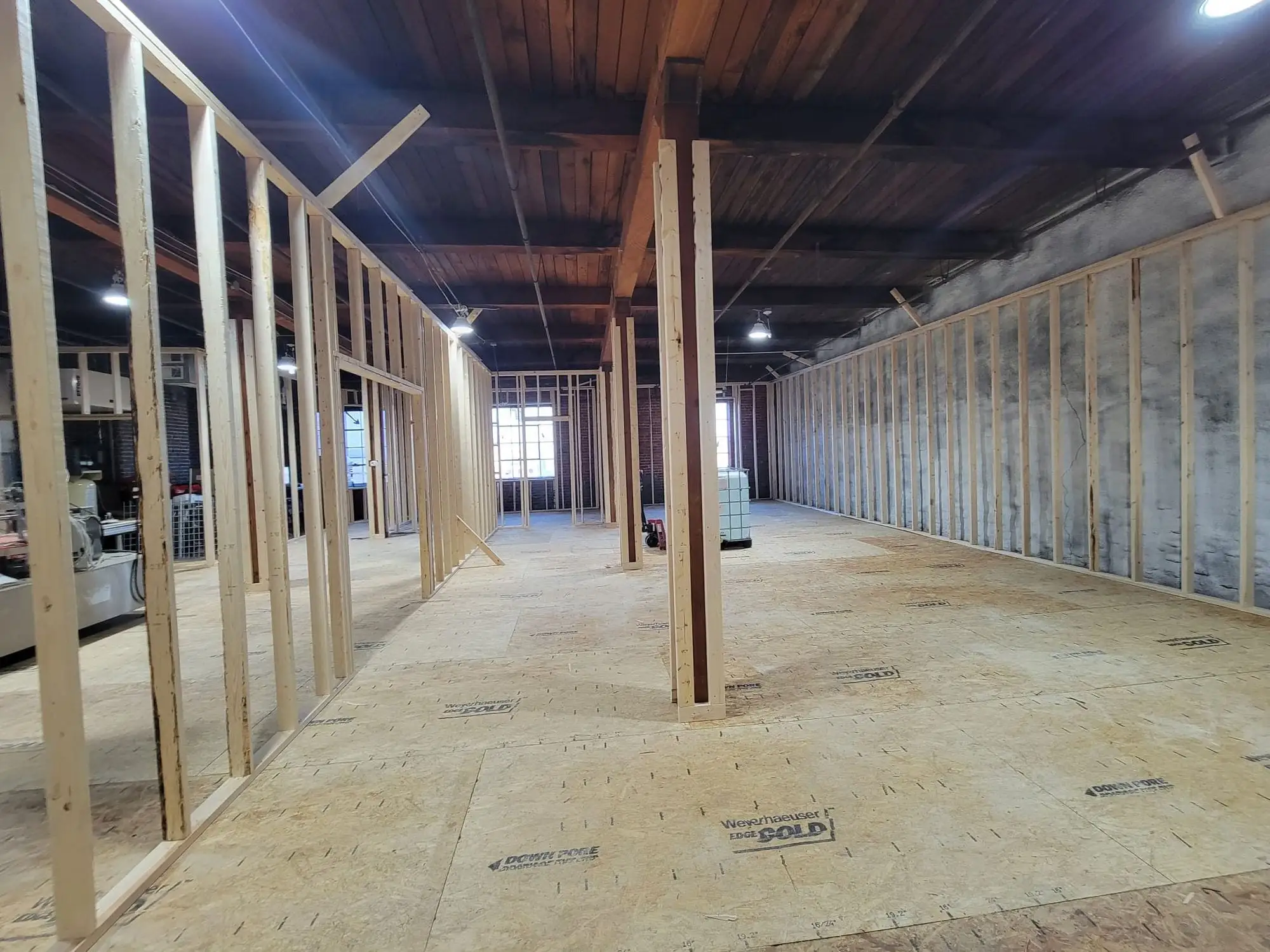 Timber stud partitions framed out across a commercial floor under an exposed timber ceiling