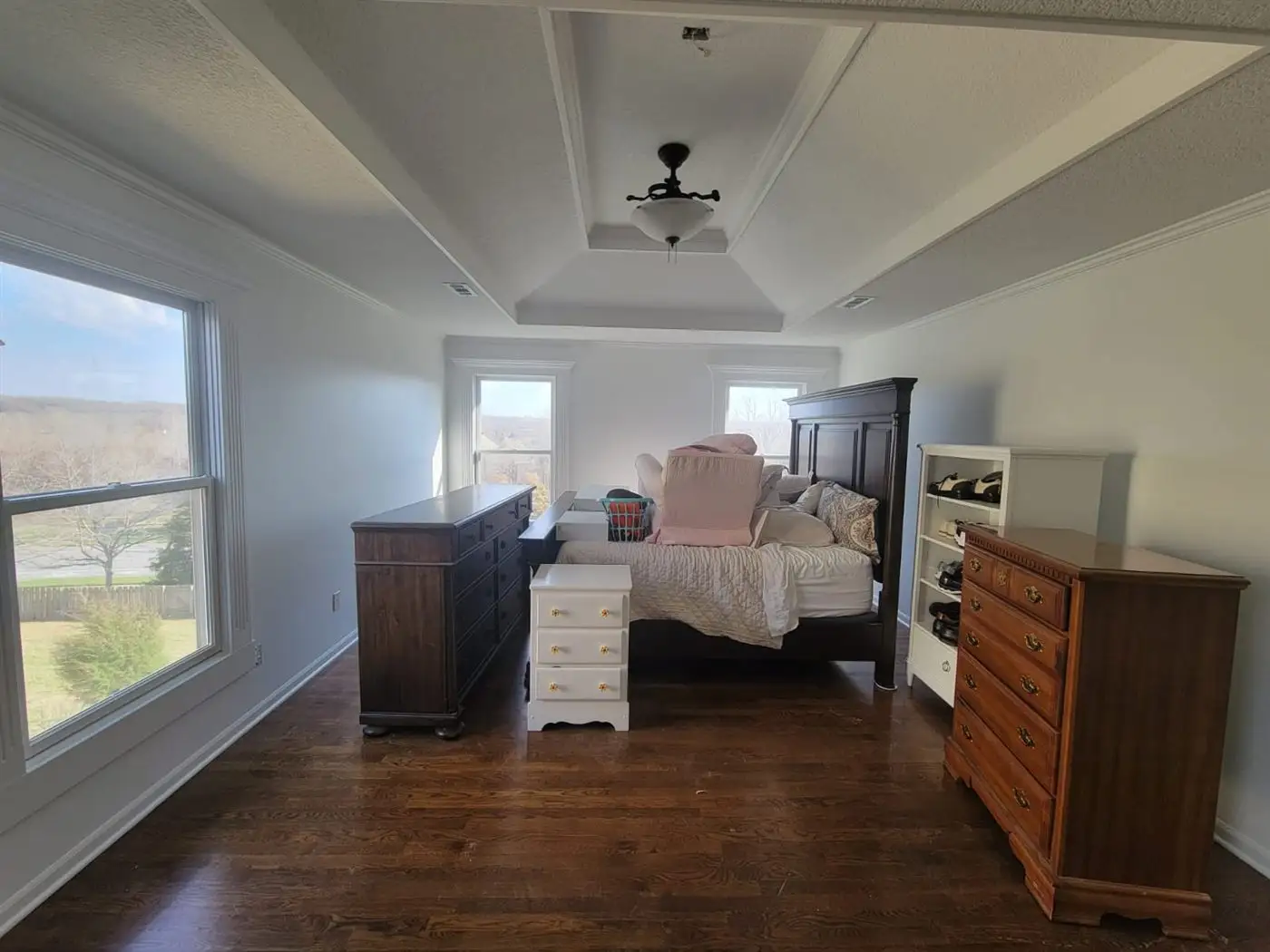Finished bedroom with wood flooring and freshly painted walls