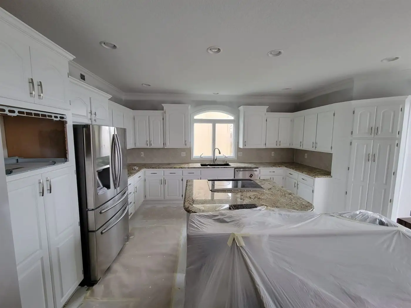 Kitchen with white cabinets after refinishing