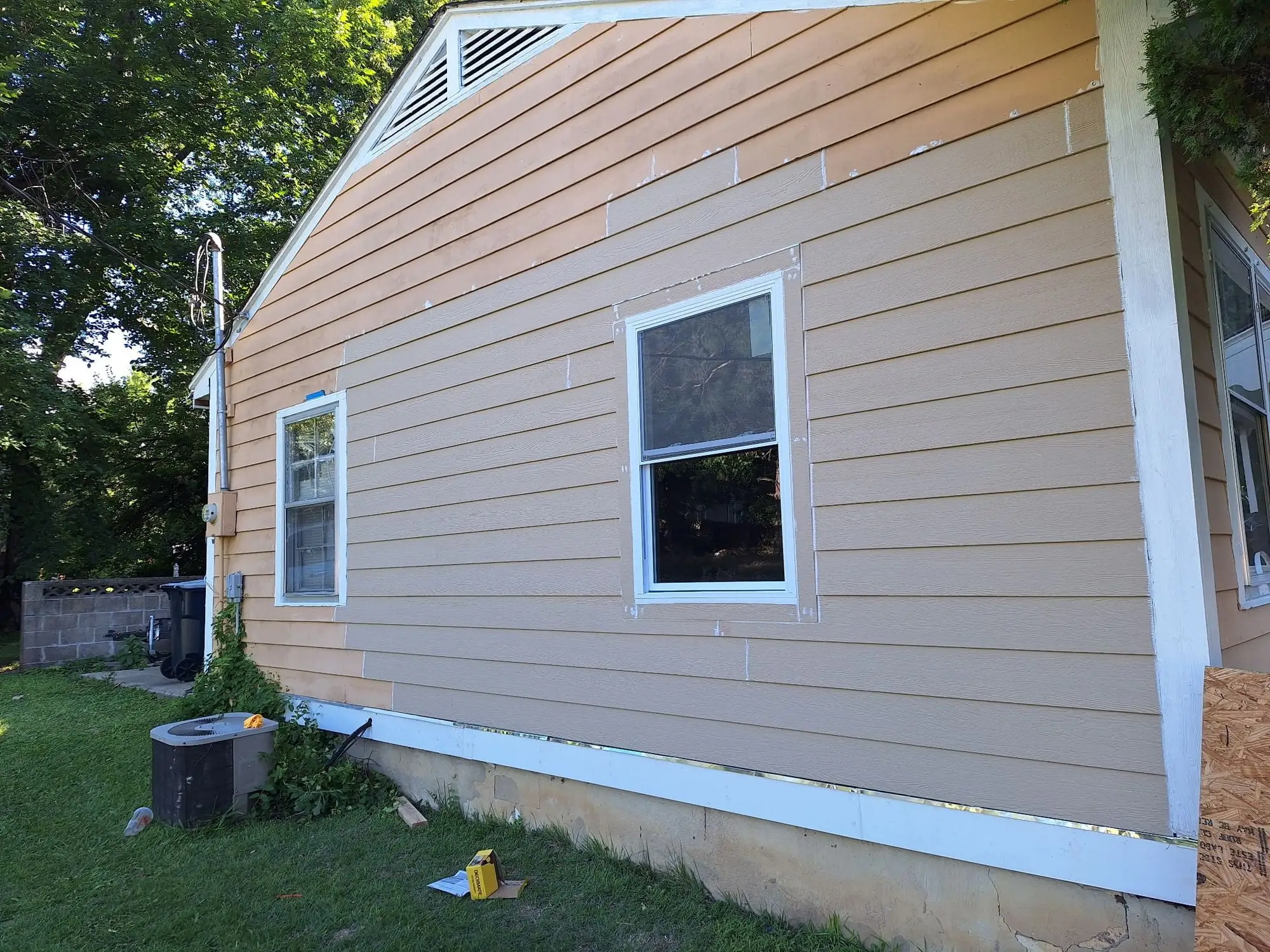 House side wall with replacement lap siding and fresh white trim